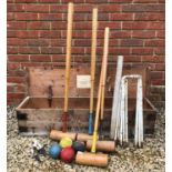 An old croquet set by FH Ayres Limited 'The Wimbledon', consisting of four mallets, six white