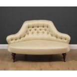 A Victorian shaped low conversation seat with button upholstered back and turned tapering legs to