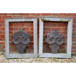 A pair of painted cast terracotta elements possibly Dutch gable ends, each 39cm wide together with