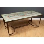 A rectangular wrought iron and brass table the top inset with a painted panel with glass, square