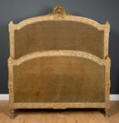A late 19th / early 20th century double bedstead with painted and parcel-gilt gesso ornament with