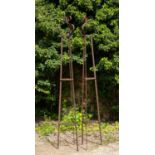 A pair of wrought iron garden stands or obelisks of triangular section with scroll tops, each