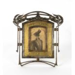 A French Art Nouveau wrought iron photograph frame, hammered brass insert and hinged support, 25.5cm