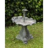 An old cast lead fountain with shell shaped bowl supported by three dolphins, 36cm diameter x 48cm