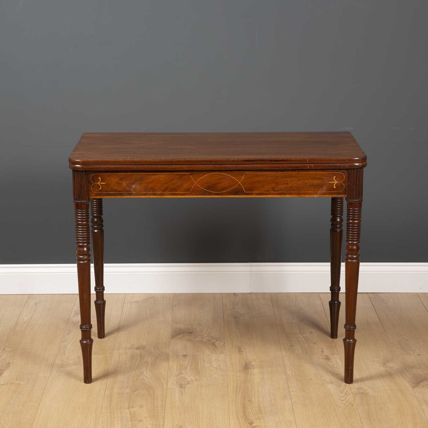 A George III fold over tea table with ring turned tapering legs and decorative inlay to the frieze - Image 4 of 5