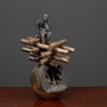 A contemporary ceramic sculpture in the form of a figure on a pile of sticks, unsigned, 41cm