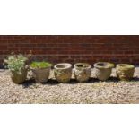 A group of cylindrical cast reconstituted stone garden planters each approximately 28cm diameter (