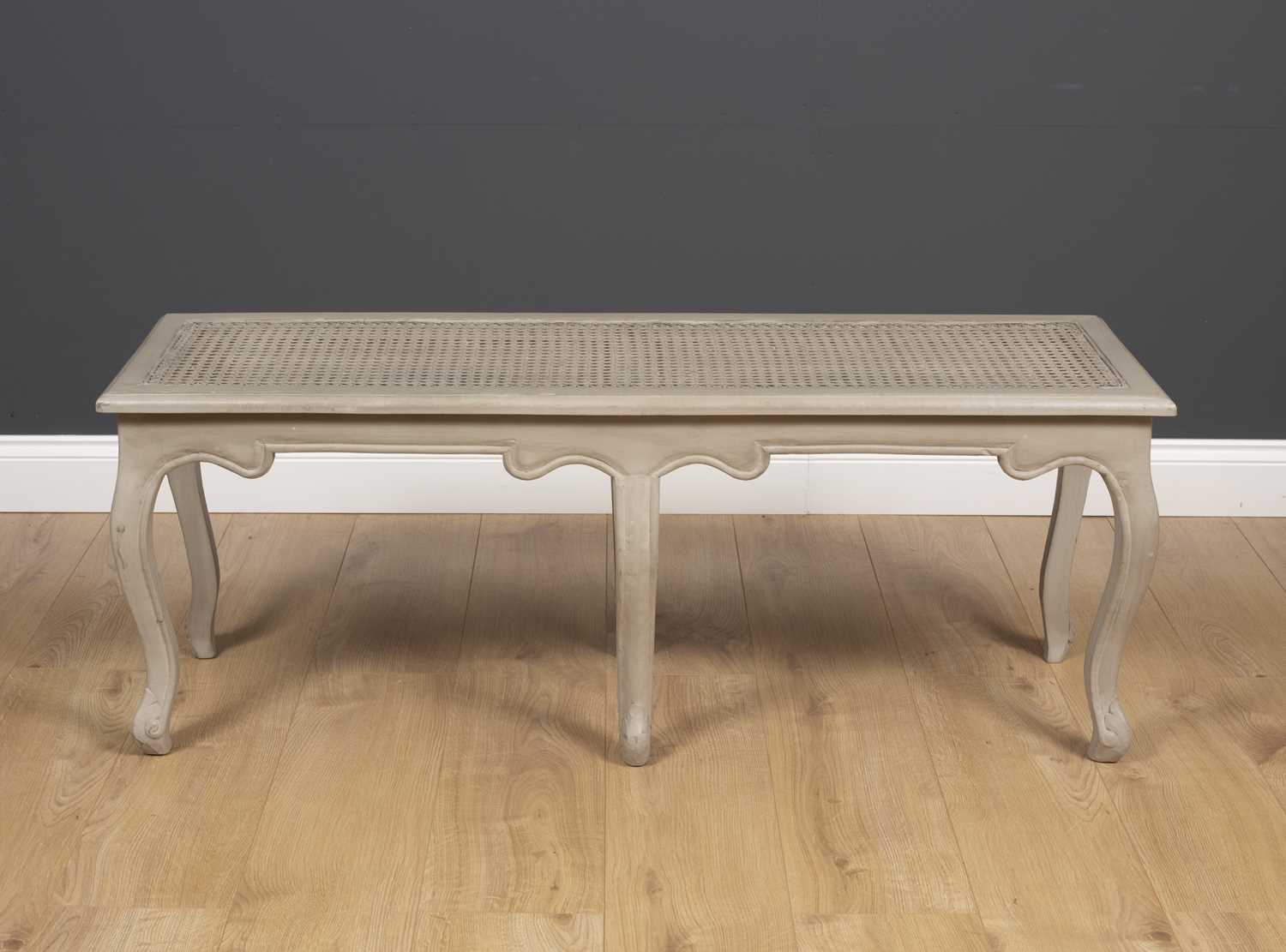 A grey painted 18th century French style window seat, with carved cabriole legs, 120.5cm wide x 40cm