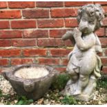 A small cast reconstituted stone sculpture of a boy with a flute, approximately 40cm high together