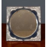 An Edwardian silver mounted dressing table mirror with bevelled mirror plate, blue velvet ground and