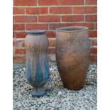 Two Barbara Tribe terracotta pots pierced with holes to the base, the larger 23cm wide x 45cm