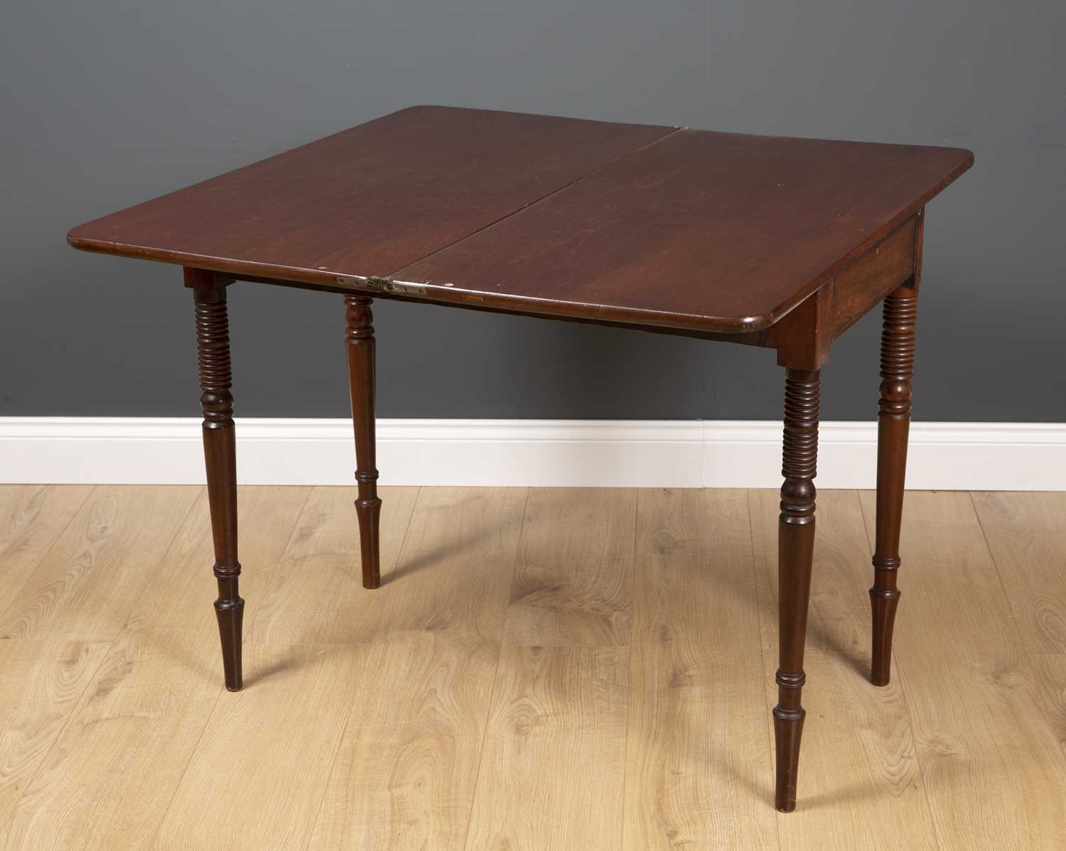 A George III fold over tea table with ring turned tapering legs and decorative inlay to the frieze - Image 5 of 5