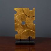 An ornamental gilt carved wooden abstract sculpture on a rectangular ebonised base, 22cm wide x 38.