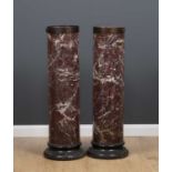 A pair of Scagliola marble columna sculpture plinths or torchieres with turned black painted bases