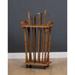 An oak stick stand for displaying walking sticks, with turned supports together with a group of