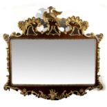 An 18th century style mahogany and gilt wall mirror, the shaped and pierced top with gilt hoho