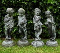 A group of four antique lead allegorical sculptures of children representing the four seasons,