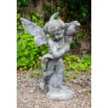 A lead fountain head in the form of cupid grasping a large fish, 64cm highCondition report: in