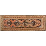 An antique Oriental brown ground runner, the central field with four diamond motifs and decorated