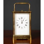 A late 19th century French carriage clock with a white enamel dial, having roman numerals, a