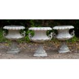 A set of three antique French cast zinc white painted garden urns with pierced rims, figural