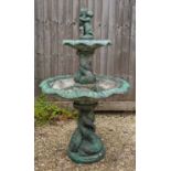 A green painted cast reconstituted stone two tier fountain with scalloped shaped bowls, the larger