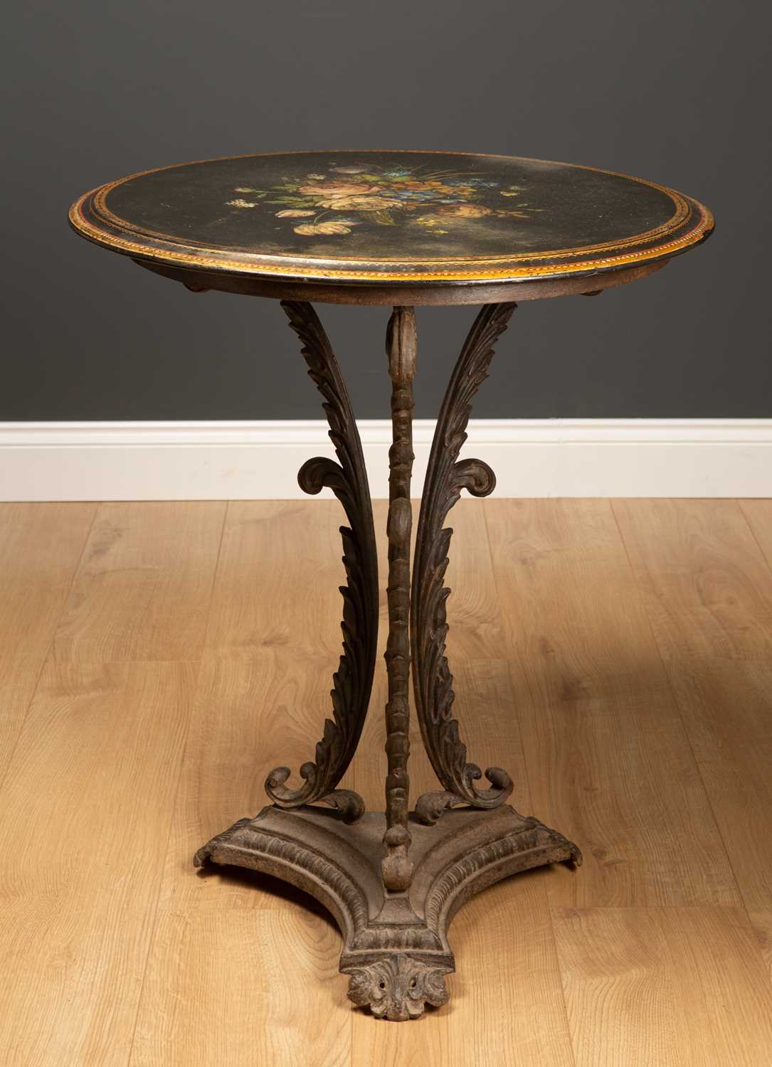 A Victorian circular occasional table with painted slate top and cast iron base with acanthus leaf