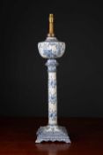 An antique Dutch delftware table lamp with oil reservoir, fluted column and square base, later