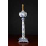 An antique Dutch delftware table lamp with oil reservoir, fluted column and square base, later