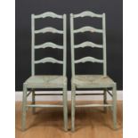 A pair of green painted ladderback occasional chairs with rush seats, 42cm wide x 107cm highQty: