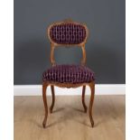 An antique French side chair with carved ornament, overstuffed upholstered back and seat and