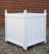 A white painted wooden garden planter with turned finials and associated zinc liner, 61cm x 61cm x