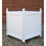 A white painted wooden garden planter with turned finials and associated zinc liner, 61cm x 61cm x