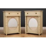 A pair of green painted bedside cabinets, each with a mirrored door above a single drawer, all on