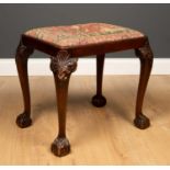 A George III style mahogany dressing table stool with inset needlework seat, shell carved cabriole