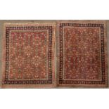 A near pair of Persian style red and blue ground rugs each with geometric decoration, 180cm x