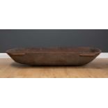 An ethnographic Pacific Island large feasting bowl in carved hardwood, with lug handles to the