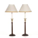A pair of George III style mahogany and brass table lamps with fluted column supports and turned