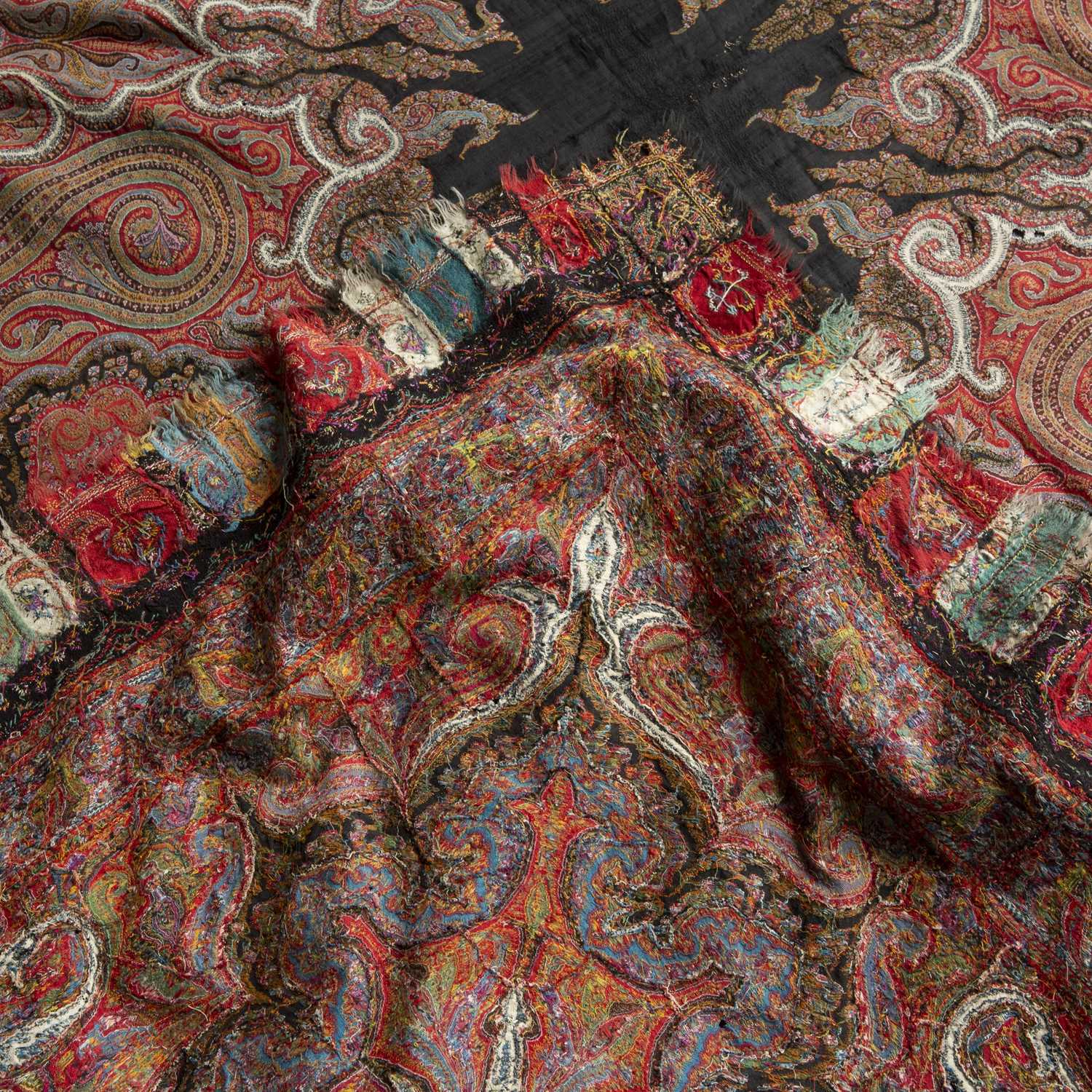 A 19th century Kashmiri shawl, the central black radiating medallion in a red field of scrolls - Image 2 of 2