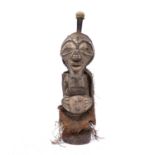 A Songye power figure, carved wood with studded decoration to face and a hessian cape, 48cm high