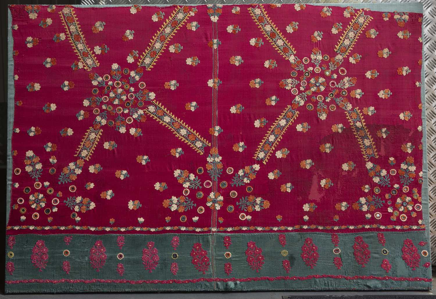 A Pakistan, Sind, finely embroidered wedding shawl fragment with star and florette design on a red