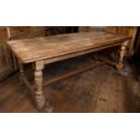 A 19th century pine refectory style kitchen table, on turned legs with 'H' stretcher, 213cm long