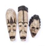 Three Fang masks, Gabon, all carved from wood with incised line marks and white pigments (3) tallest