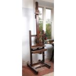 A Victorian mahogany artist's easel, with adjustable column, and shaped base with castors, 66cm