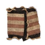 An African Ceremonial Kuba dance skirt, raffia and cloth, with embroidered long panels, a dyed cut
