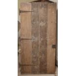 A 17th/18th century oak door, of plank construction, with iron strap hinges, 181 x 88cm