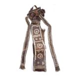 A Large Ethiopia ceremonial leather apron, decorated with cowrie shells, 180cm long approx.