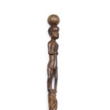 A Zimbabwe carved wood prestige or dancing stick of figure and snake form, 91cm long