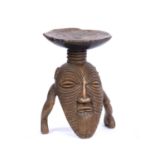 A Luba songye circumcision stool, carved wood squatting legs and ribbed face to a pillar topped by a