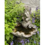 A sundial, on reconstituted stone baluster stand, 71cm high; together with a cherub and scallop bird